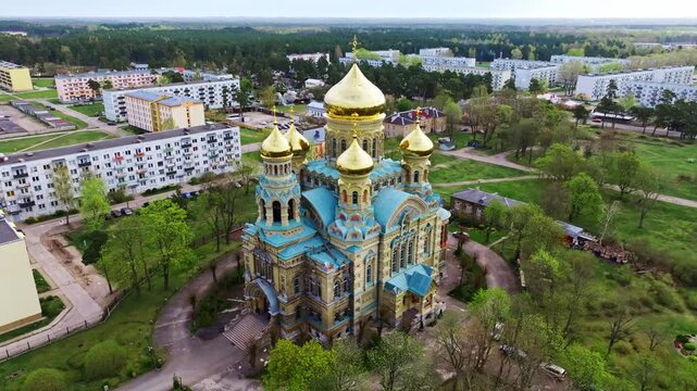 Golden domes rise above fresh greenery, showcasing cultural heritage and faith