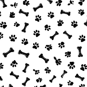 Seamless black and white pattern of dog paw prints and bones with a playful grunge texture
