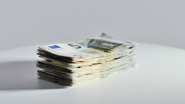 Rotating stack of euro currency notes represents budgeting wealth and trade