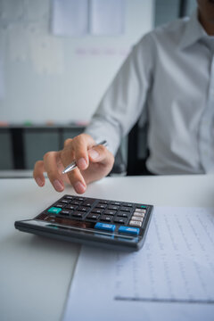 Accountant using calculator calculate document