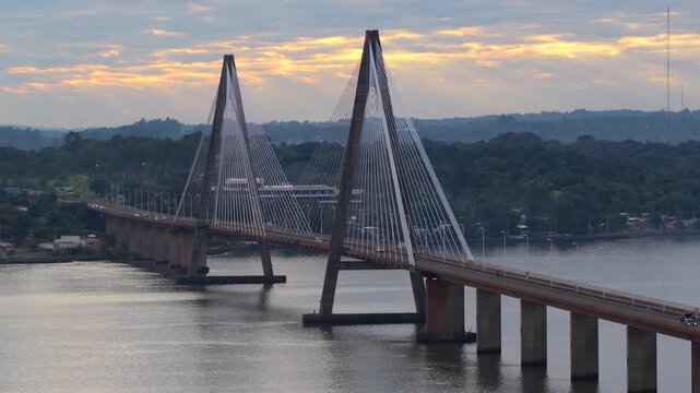 Aerial sunrise view of the iconic San Roque Gonzalez Bridge spanning the Parana River between Argentina and Paraguay.