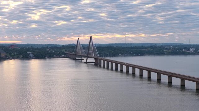 Aerial sunrise view of the San Roque Gonz&aacute;lez de Santa Cruz Bridge connecting Posadas and Encarnaci&oacute;n.