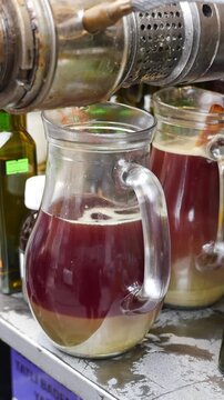 black cumin seed oils pouring in a jar