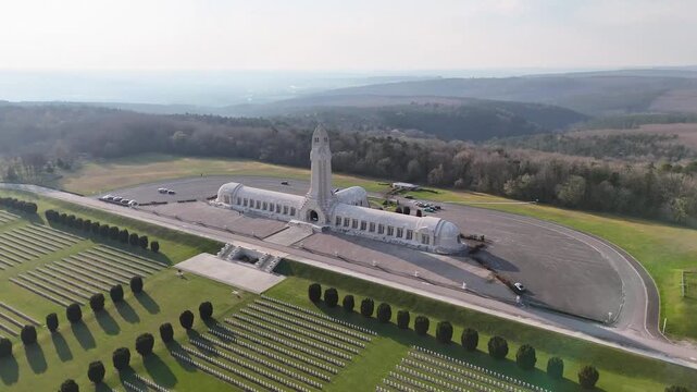 Drone view of Douaumont Ossuary and French military cemetery near Verdun, Meuse, France, with rows of white crosses and memorial grounds.