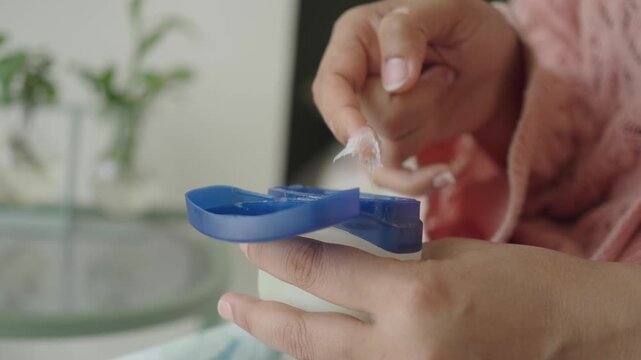 Applying petroleum jelly for skin care routine in the morning
