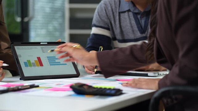 Businessman collaborate on project analysis with financial graphs. Strategic teamwork and insights drive company growth and success.