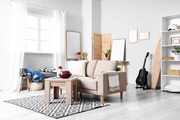 Modern living room interior with comfortable sofa, coffee table, and sports decor for relaxed home environment © Pixel-Shot
