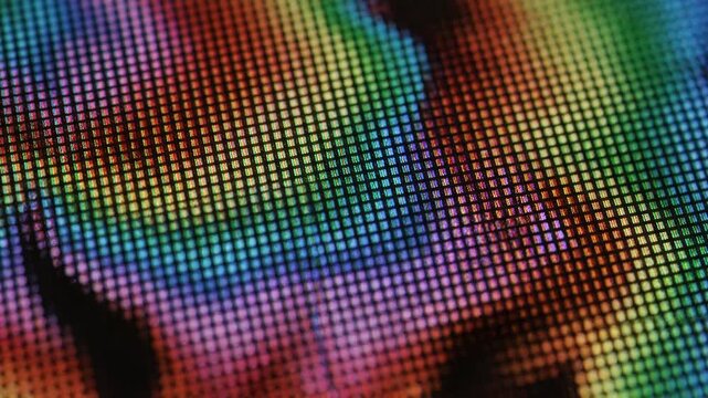 A close-up macro photograph showcasing a vibrant and abstract spectrum of rainbow colors on a digital screen, emphasizing pixelation and light diffusion