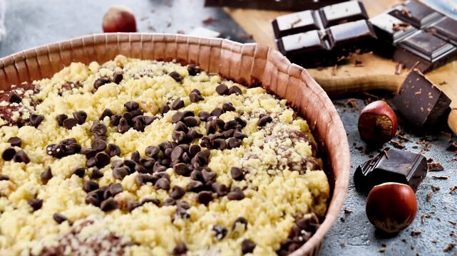 Homemade chocolate chip crumble cake with dark chocolate bars and hazelnuts, cookies, brookie