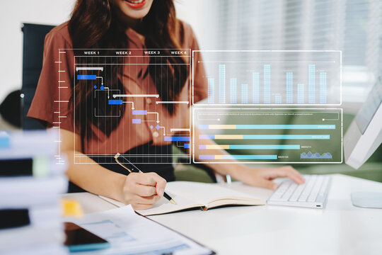 Businesswoman hand Project manager working and update tasks and Gantt chart scheduling virtual diagram.with smart phone, tablet and laptop