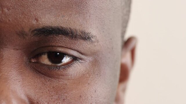 Blink, eye and vision with black man in studio for optometry appointment or checkup. Healthcare, optical and eyesight with patient at ophthalmology assessment for visual correction or improvement
