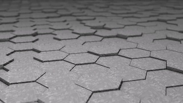A 3D animated visualization of a gray hexagonal floor or geometric surface with a texture resembling a digital circuit board. 
