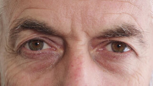 Blink, eyes and vision with mature man closeup for optometry appointment or checkup. Healthcare, optical and eyesight with person at ophthalmology assessment for visual correction or improvement