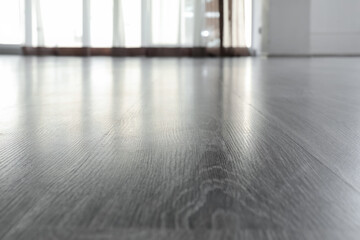 Fototapeta premium Modern gray laminate flooring with window light reflection, empty room interior design and home renovation
