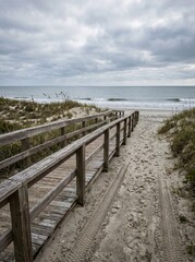Fototapeta premium Empty accessible beach ramp with wheelchair tire marks in the sand, representing inclusive tourism, mobility access, and barrier-free travel.