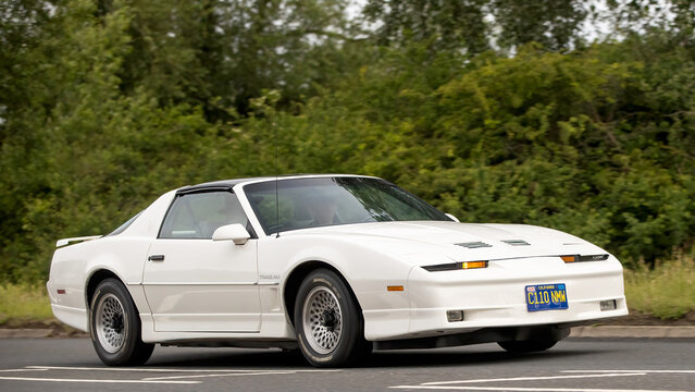 Stony Stratford,Bucks,UK - June 7th 2026: 1986 white third-generation white Pontiac Firebird Trans Am classic American car driving on a British road