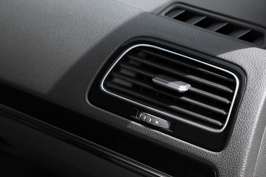 Modern car dashboard air vent with chrome trim and adjustable louvers for climate control and interior design, the automotive interior design features a textured plastic panel