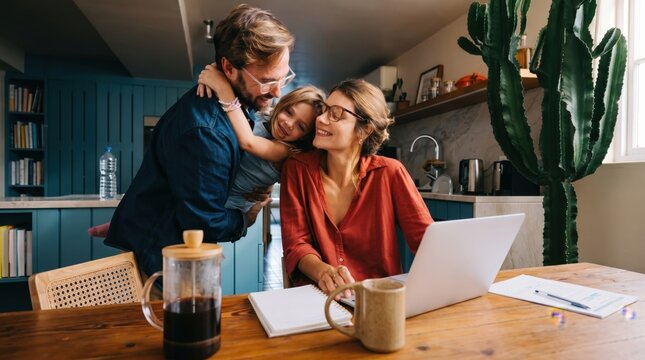 Happy family father mother and daughter spending time together at home kitchen table, remote work and parenting balance lifestyle concept with laptop and coffee