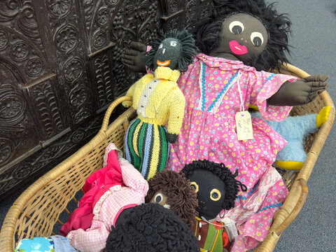 Vintage home-made golliwog dolls, antique shop display. Popular through the 20th century, now recognised as racist caricatures. Social history artefacts.