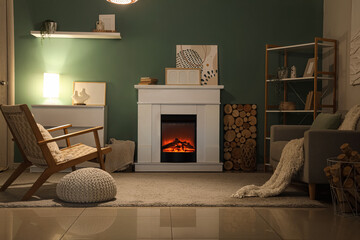 Obraz premium Cozy living room interior with electric fireplace, comfortable armchair, and warm lighting for relaxation