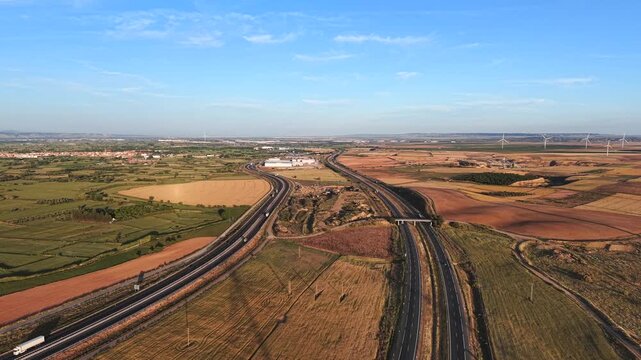 Drone video of AP-68 near Pedrola, Spain. Aerial footage of highway traffic on Spanish Autopista looking towards Zaragoza in late afternoon light.