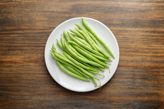 Top view of fresh green beans on white plate
