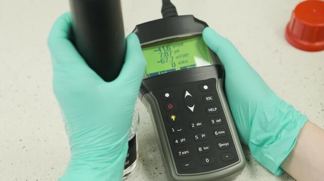 Laboratory analysis of water samples using a dual function device for pH and electrical conductivity measurement. Scientific research in environmental chemistry and water quality control.