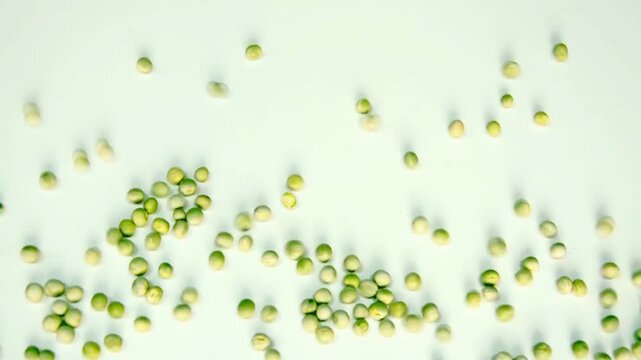 Stop-motion style animation of organic green peas filling a white background