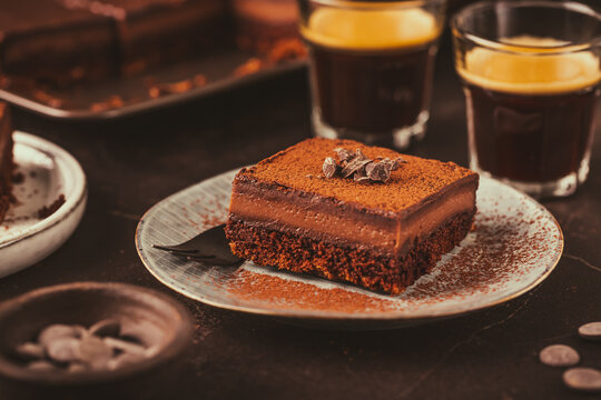 Homemade French layered chocolate cake with two cups of coffee