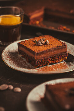Homemade French layered chocolate cake with two cups of coffee