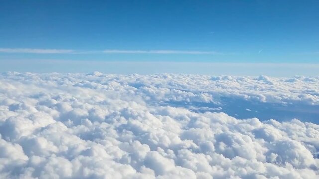 Stunning panoramic view of the horizon and a soft cloudscape from a passenger plane window