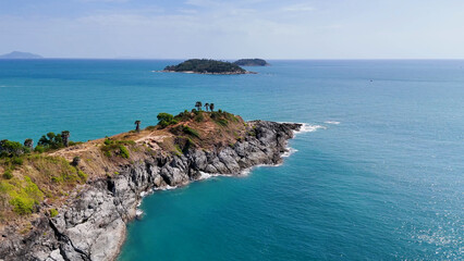 Obraz premium Aerial View of Promthep Cape Rugged Cliffs and Turquoise Ocean