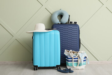 Obraz premium Travel preparation with blue and cyan suitcases, beach bag, and vacation accessories for summer getaway