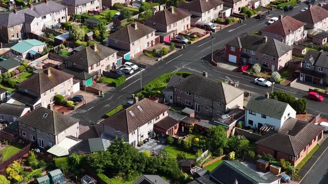 Aerial close up of a residential housing estate in Penrith Cumbria England showing detached and semi detached family homes private gardens driveways quiet suburban streets and neighbourhood living