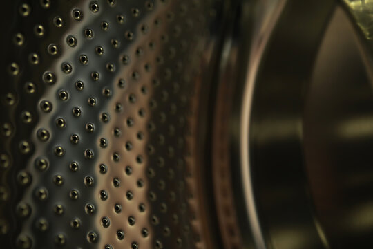 Close-Up of Washing Machine Drum - Metallic Surface and Perforations