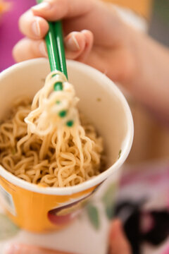 looking into a half eaten cup of instant ramen noodles
