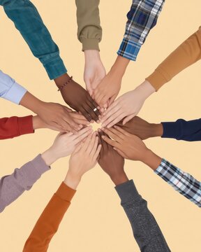 Diverse group of people putting their hands together in a circle to show unity cooperation and team spirit at work