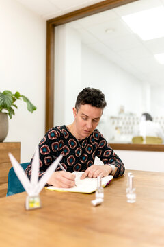 Woman evaluating perfume scents and taking notes