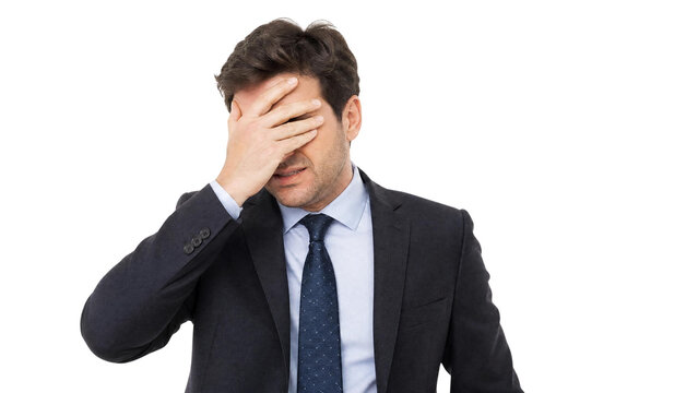 Stressed Businessman in Suit Covering Face with Hand in Disappointment