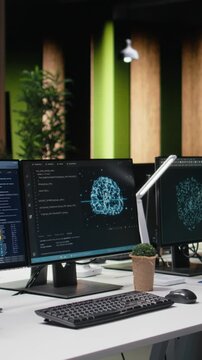 Vertical screen view of computer in Silicon Valley company office automating app development tasks with machine learning.