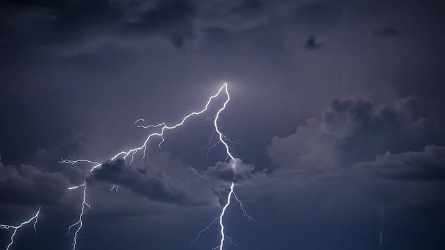 A bright bolt of lightning strikes through the dark and heavy storm clouds above