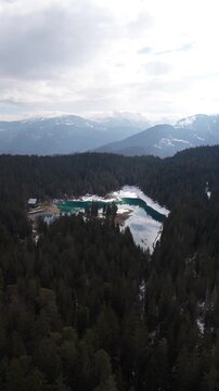 Switzerland winter scene Lake Cauma Caumasee Swiss alpine region, aerial drone