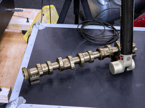 Portable Coordinate Measuring Machine CMM Arm Inspecting a Metal Engine Camshaft for Precision Quality Control