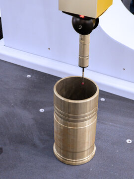 Precision Coordinate Measuring Machine (CMM) Inspecting Cylindrical Metal Part in Manufacturing Lab