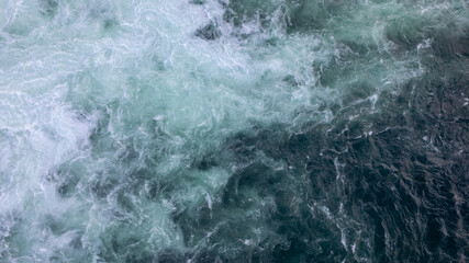 Obraz premium Turbulent Water with White Foam and Dark Flowing Surface
