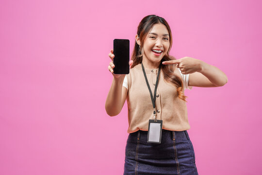 Beautiful young Asian woman is smiling while showing the copy space on phone screen.