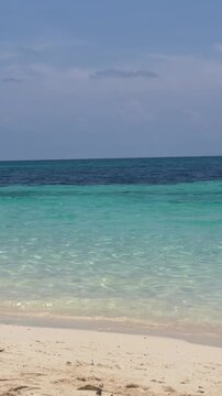 Visual contrast of clear shallow turquoise sea water and deep blue ocean under a bright sky, tropical coastal background, Boracay, Philippines.