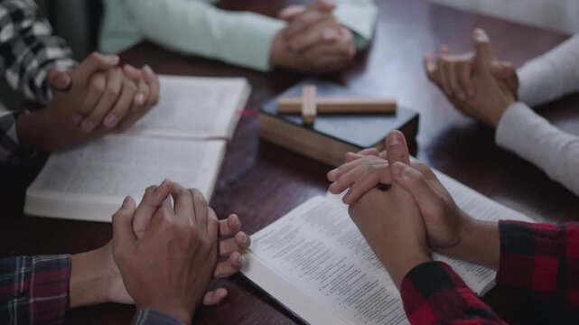 Group of Christians are congregants  to pray and seek the blessings of God, the Holy Bible. The cross symbol. They were reading the Bible and sharing the gospel, teamwork.