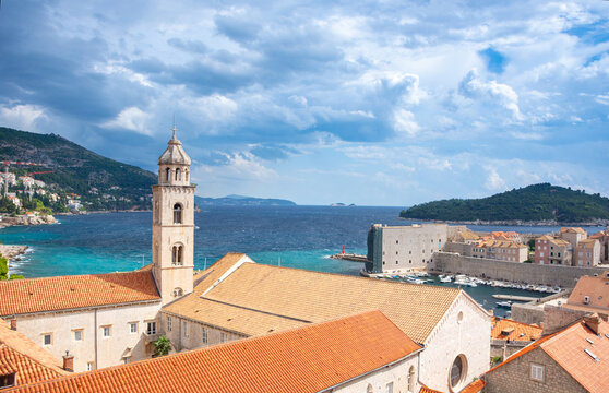 Dubrovnik Old Town with red terracotta roofs, the historic bell tower of the Dominican monastery and the harbor on the blue Adriatic Sea, in Croatia
