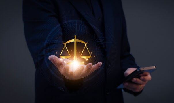 Hand presenting digital justice scale, representing AI ethics, fairness, data privacy, legal compliance, transparent decisions and responsible technology governance